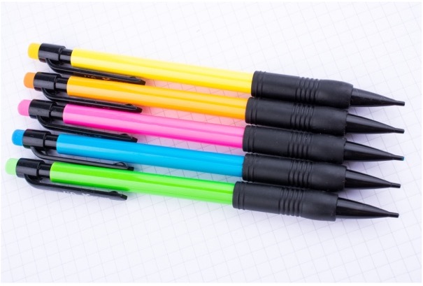 A group of pens on a graph paper